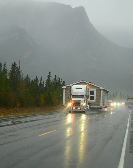 truck moving a mobile home on a highway